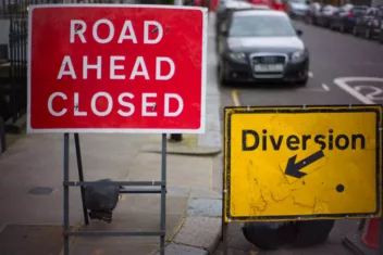 Road signs, road ahead closed and diversion with a wonky arrow