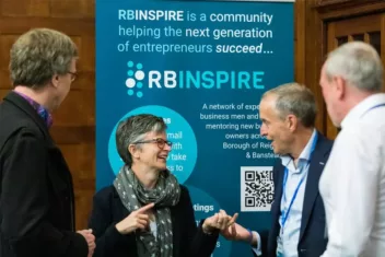 Four people chatting at RBInspire stand